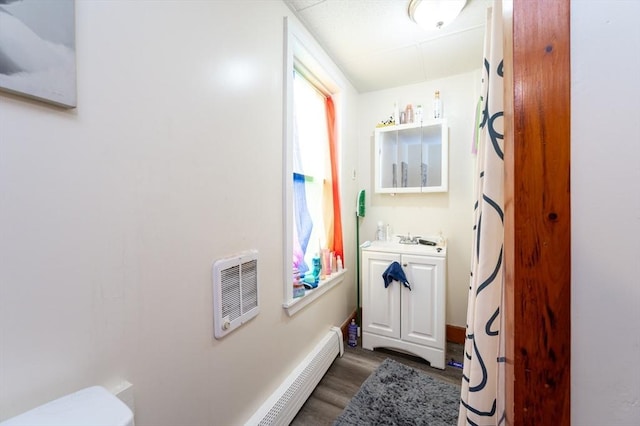 8 Everett St, Somerville, MA 02143 - bathroom featuring wood finished floors, vanity, a baseboard heating unit, and heating unit