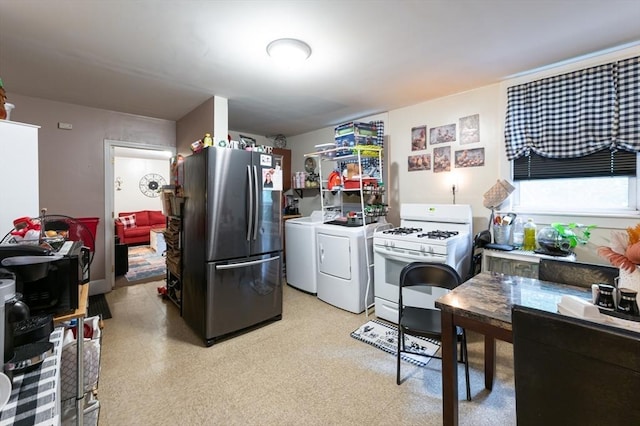 8 Everett St, Somerville, MA 02143 - kitchen with freestanding refrigerator, white gas range oven, washer and dryer, and light floors