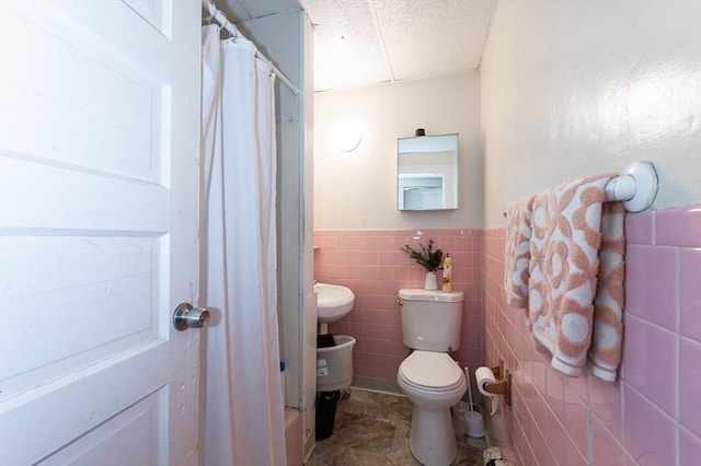 8 Everett St, Somerville, MA 02143 - bathroom featuring a drop ceiling, wainscoting, a shower with shower curtain, and tile walls