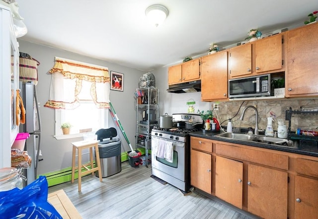 8 Everett St, Somerville, MA 02143 - kitchen with stainless steel gas range oven, black microwave, tasteful backsplash, under cabinet range hood, and light wood-style floors