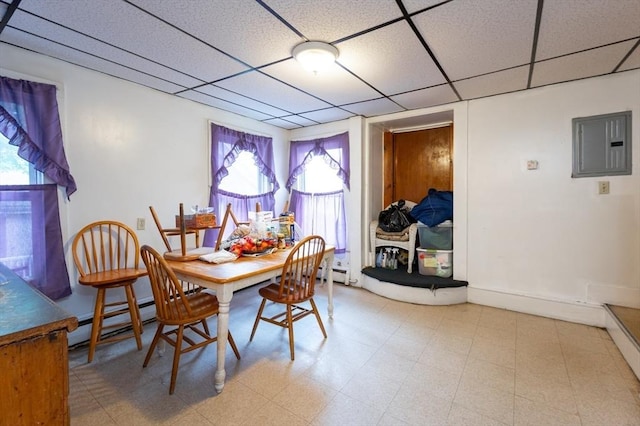 8 Everett St, Somerville, MA 02143 - dining space featuring electric panel, baseboard heating, healthy amount of natural light, a drop ceiling, and light floors