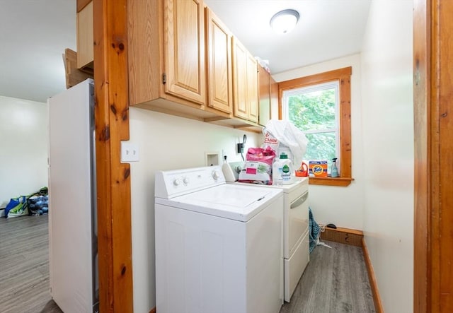 8 Everett St, Somerville, MA 02143 - laundry area featuring cabinet space, washer and clothes dryer, and light wood-style floors