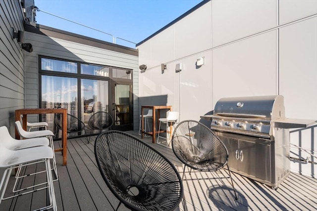 wooden deck featuring a grill