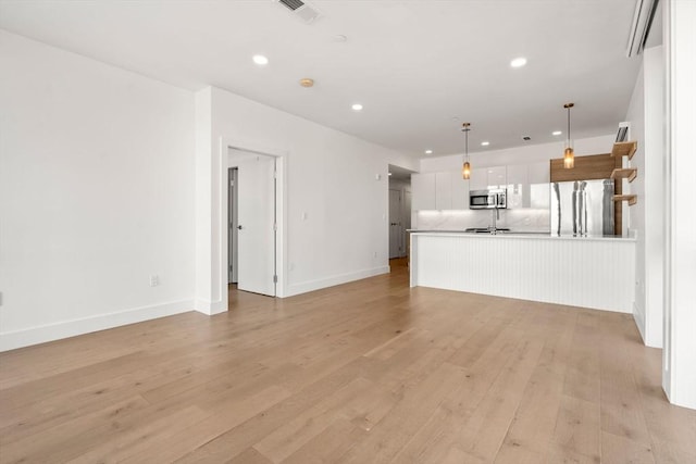 unfurnished living room featuring light wood-type flooring