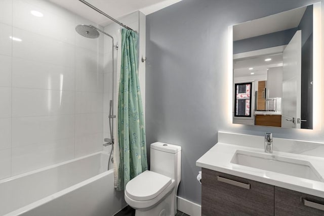 full bathroom with vanity, shower / tub combo, and toilet