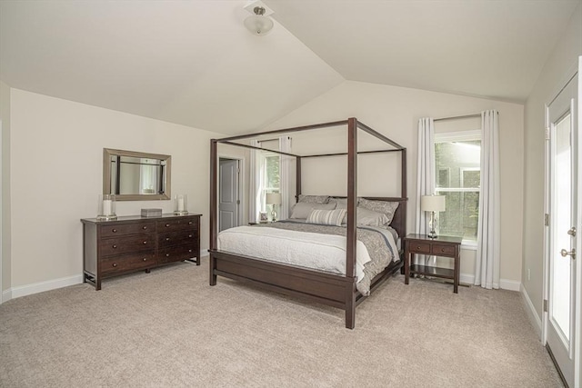 bedroom featuring light carpet and lofted ceiling