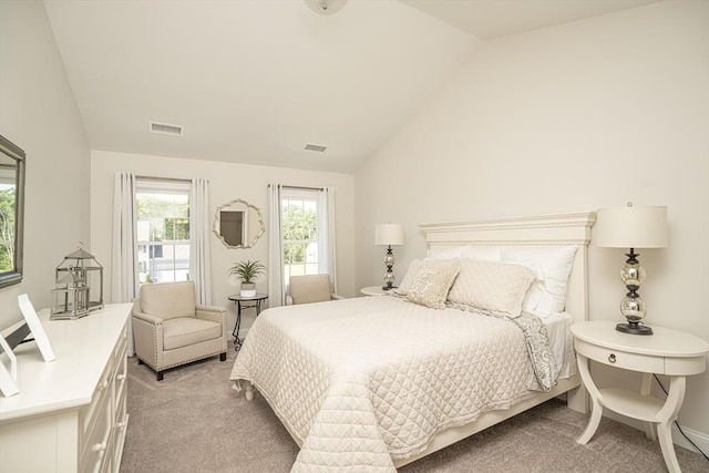 carpeted bedroom with lofted ceiling