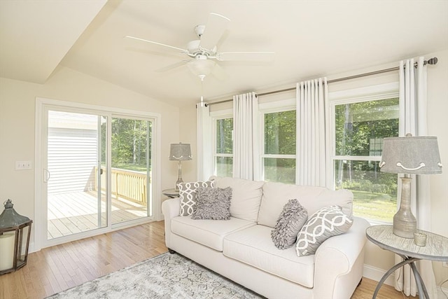 living room with hardwood / wood-style flooring, lofted ceiling, and ceiling fan