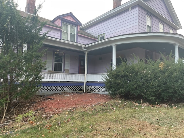 view of side of home with a porch