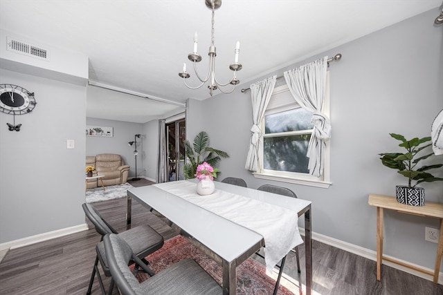 dining space featuring an inviting chandelier and dark hardwood / wood-style floors