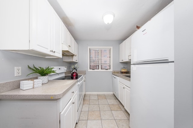 kitchen with white appliances, light tile patterned floors, and white cabinets