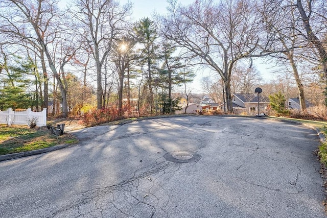 view of street with curbs, street lighting, and a residential view