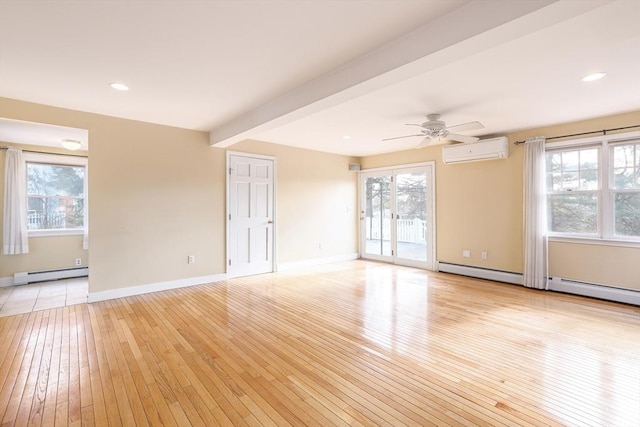 empty room with light wood finished floors, a baseboard radiator, an AC wall unit, a healthy amount of sunlight, and beam ceiling