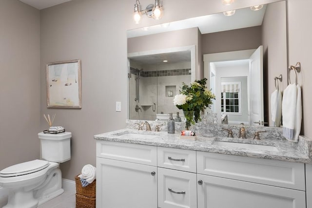 bathroom featuring tile patterned floors, toilet, vanity, and walk in shower