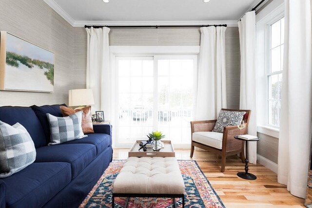 living room featuring hardwood / wood-style flooring and ornamental molding