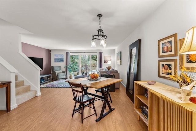 dining area featuring light wood-type flooring and radiator