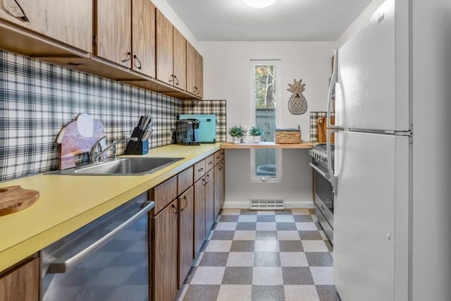 kitchen featuring backsplash, sink, and stainless steel appliances