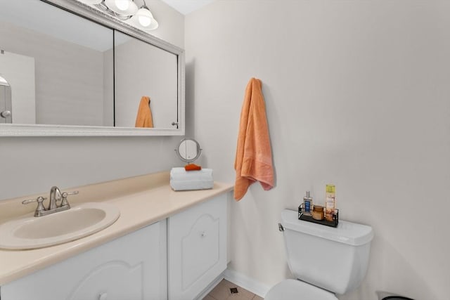 bathroom with tile patterned floors, vanity, and toilet