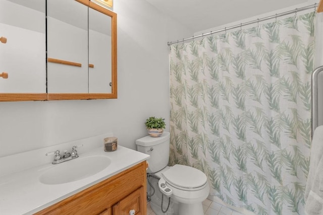 bathroom featuring tile patterned flooring, vanity, and toilet