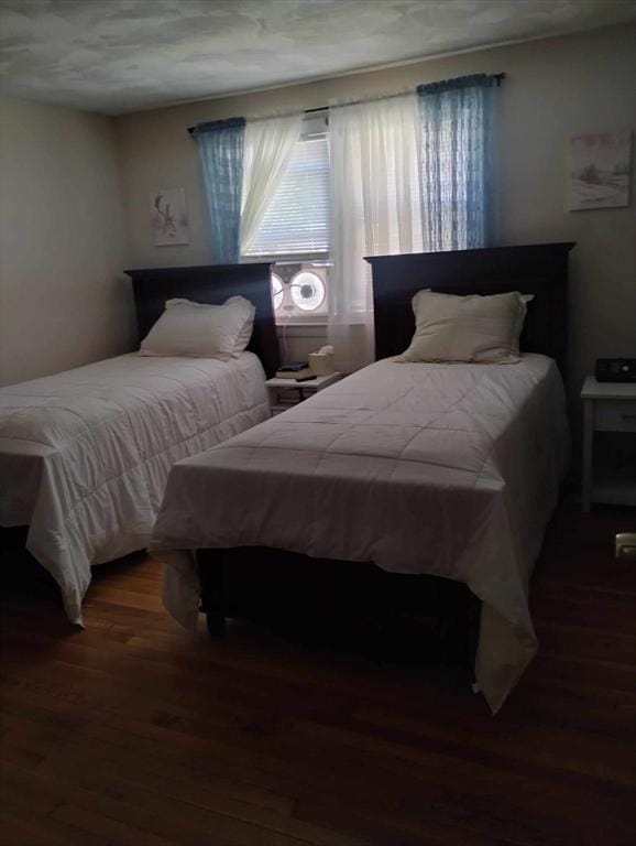 bedroom with dark hardwood / wood-style flooring