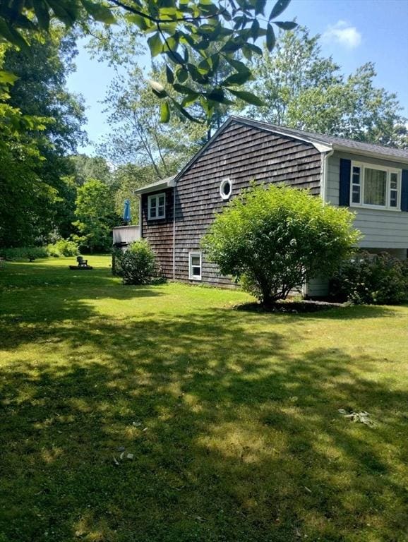 view of property exterior with a yard