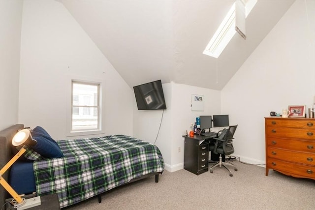 carpeted bedroom featuring lofted ceiling with skylight