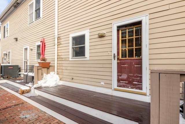 view of exterior entry featuring central AC unit