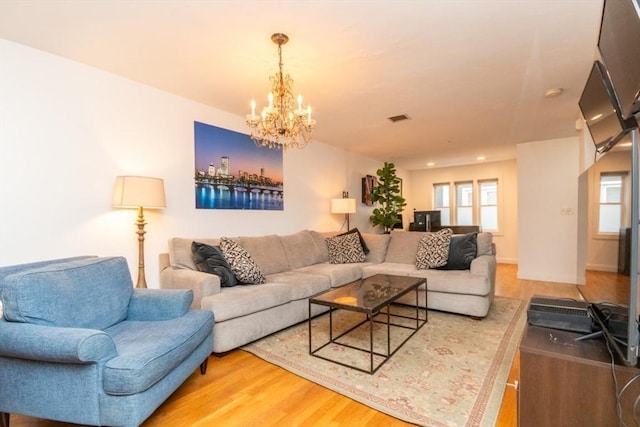 living room with hardwood / wood-style floors and a chandelier