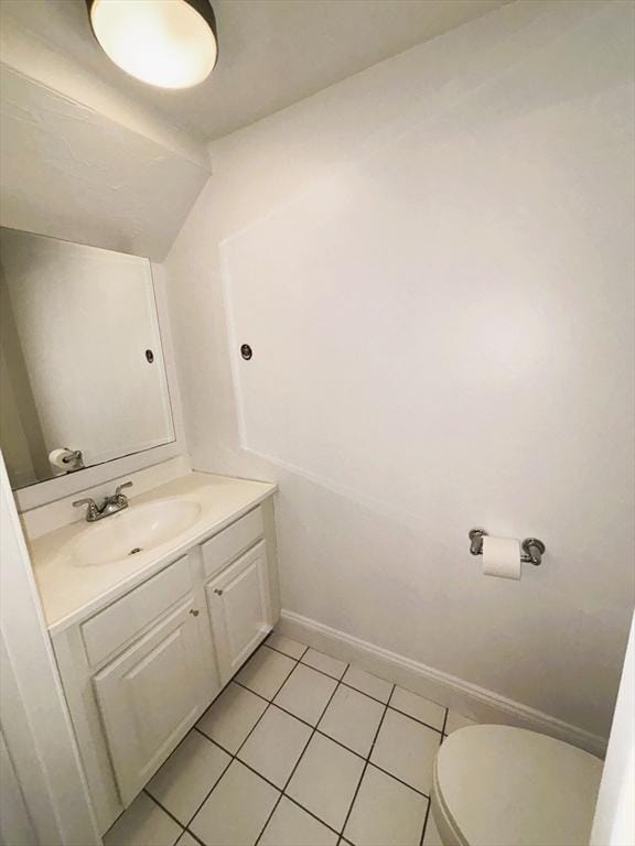 bathroom with tile patterned flooring, vanity, and toilet