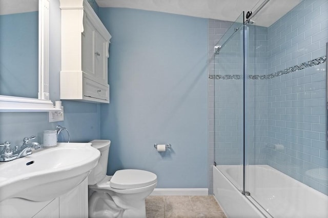 full bathroom featuring sink, toilet, shower / bath combination with glass door, and tile patterned flooring