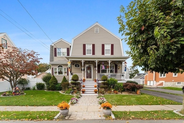 view of front of property with covered porch and a front lawn