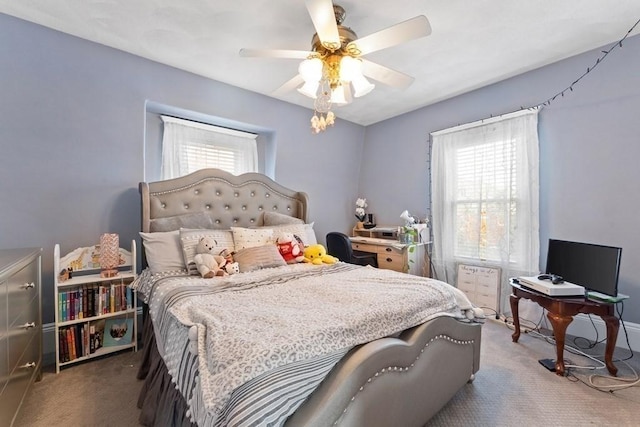 bedroom with ceiling fan, carpet, and multiple windows