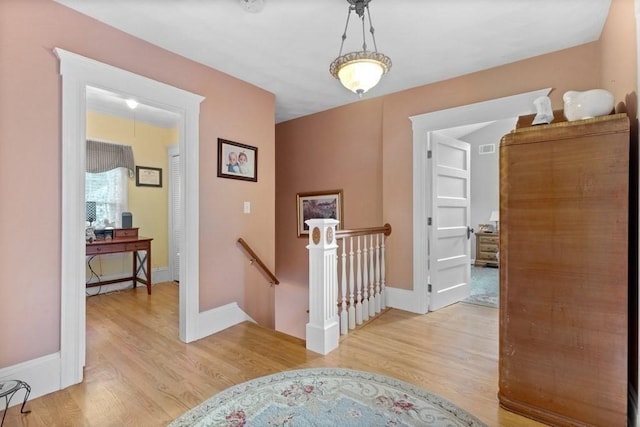 corridor with light hardwood / wood-style flooring