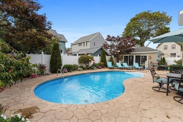 view of pool with a patio and an outdoor structure