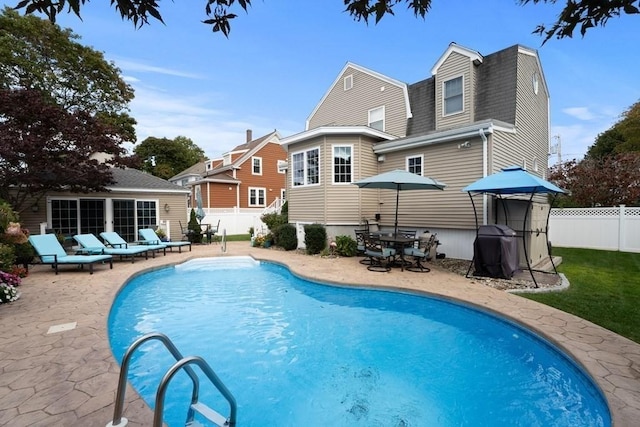 view of pool with a patio area and area for grilling