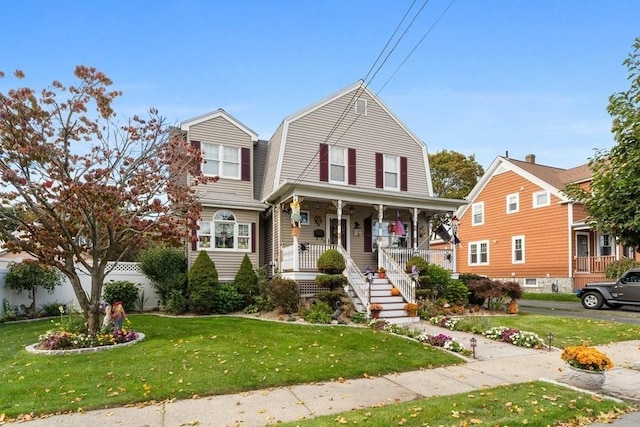 view of front of house with covered porch and a front lawn