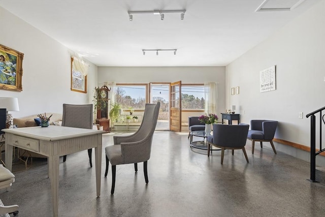 dining space featuring rail lighting and a desk