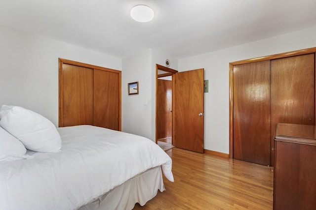 bedroom featuring light wood-style floors and baseboards