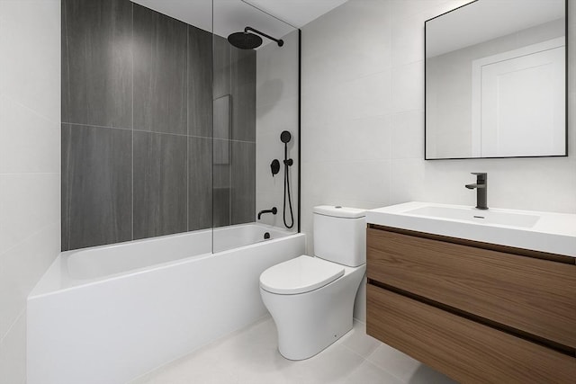 full bathroom featuring tile patterned floors, toilet, vanity, tub / shower combination, and tile walls