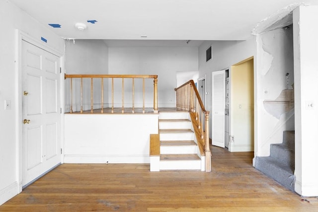 stairs featuring wood finished floors and visible vents