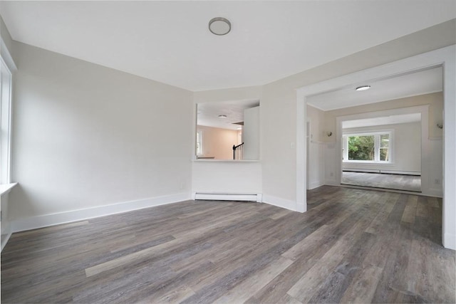 9 Garfield St, Dartmouth, MA 02748 - unfurnished living room with baseboard heating, wood finished floors, and baseboards