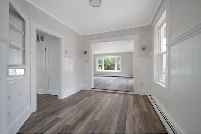 9 Garfield St, Dartmouth, MA 02748 - empty room featuring wood finished floors, a baseboard radiator, wainscoting, a decorative wall, and built in shelves