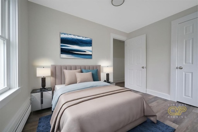 9 Garfield St, Dartmouth, MA 02748 - bedroom with baseboard heating, wood finished floors, and baseboards
