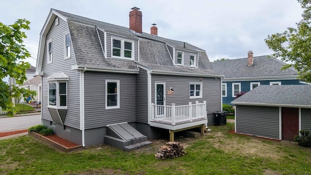 9 Garfield St, Dartmouth, MA 02748 - rear view of property featuring a yard, a chimney, roof with shingles, a gambrel roof, and a deck