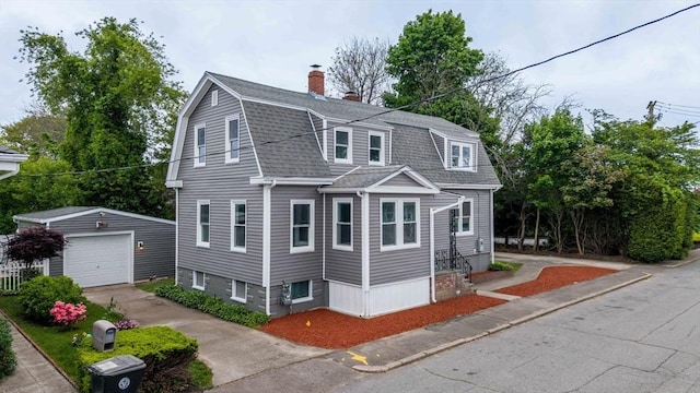 9 Garfield St, Dartmouth, MA 02748 - dutch colonial featuring a chimney, a shingled roof, an outbuilding, a detached garage, and driveway