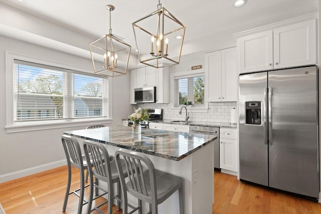 60 Starbird Ave Unit 2, Boston, MA 02131 - kitchen with stainless steel appliances, a sink, recessed lighting, a chandelier, and a center island
