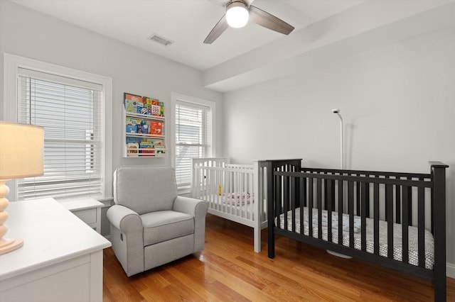 60 Starbird Ave Unit 2, Boston, MA 02131 - bedroom with wood finished floors, ceiling fan, and a nursery area