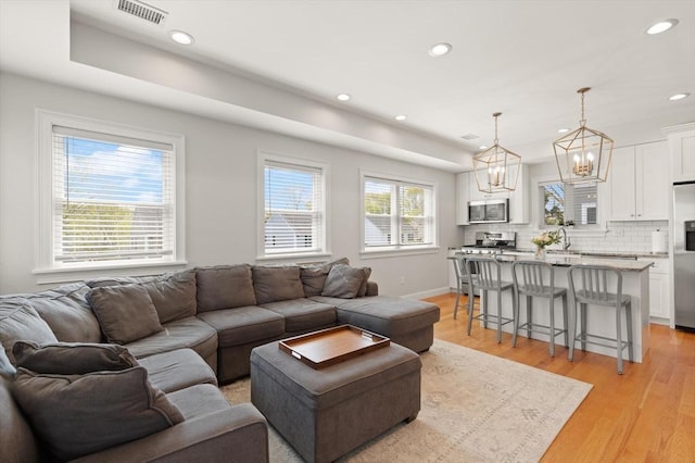 60 Starbird Ave Unit 2, Boston, MA 02131 - living area featuring a chandelier, recessed lighting, light wood-type flooring, and baseboards