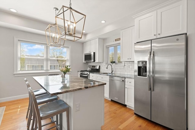60 Starbird Ave Unit 2, Boston, MA 02131 - kitchen featuring appliances with stainless steel finishes, a chandelier, a kitchen island, white cabinets, and recessed lighting