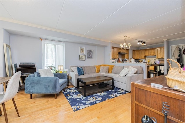280 Harvard St Unit 1A, Cambridge, MA 02139 - living room with ornamental molding, light wood-style flooring, and a chandelier